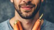 Man with carrots as beard sticks, playful concept of healthy eating and lifestyle.
