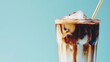 Iced coffee with creamy swirls in a glass, refreshing beverage concept.