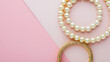 Top view of golden with pearl bracelets on pink an Jewelry made of white pearls Young businesswoman checks her jewelry after finishing it, measures it and enjoys her new endeavor, Generative Ai
