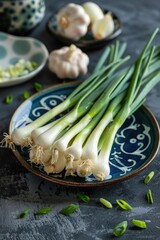 Wall Mural - A plate of green onions sits on a table with other vegetables