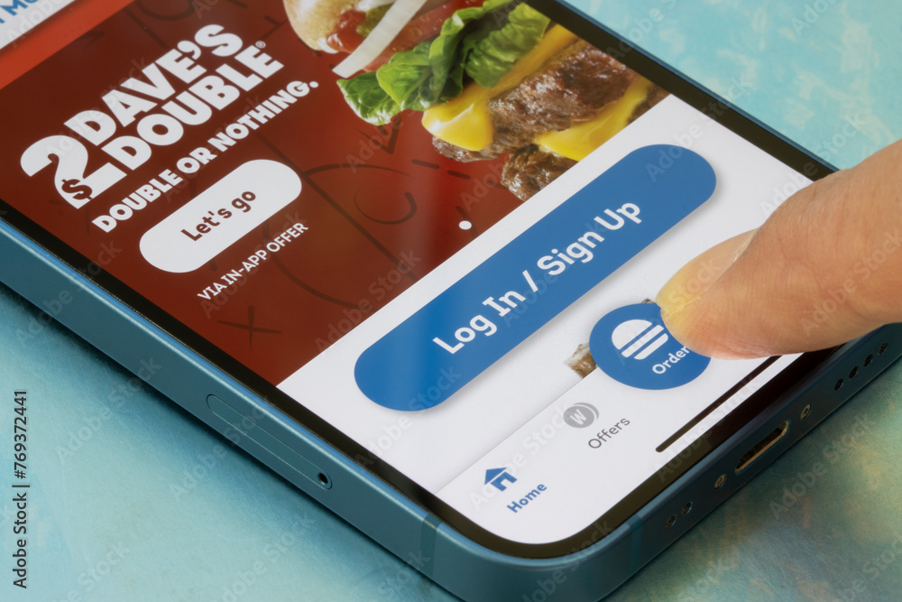 Portland, OR, USA - Mar 7, 2024: Finger touching the order button in ...