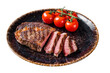 Grilled rib eye steak, ribeye beef marbled meat on a plate with tomato.  Isolated, Transparent background.