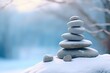 Four smooth beach stones stacked and balanced on a driftwood log, shallow depth of field, peace, balance and creation concepts