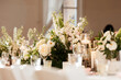 © Cavan Images - White wedding reception decor with elegant candles