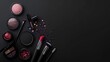 Makeup brushes and cosmetics on black background. Top view with copy space