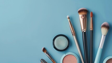 Wall Mural - Makeup brushes and cosmetics on blue background. Flat lay, top view.