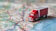 A toy truck is parked on top of an interstate map, showcasing logistics and transportation planning