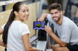 © auremar - gym class working out on rowing machines together