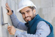 happy man with trowel plastering a wall