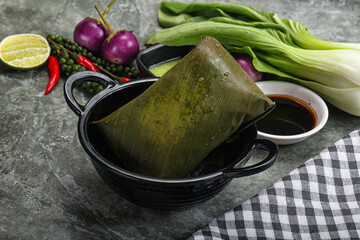 Wall Mural - Asian cuisine - rice with filling in banana leaf