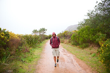 Canvas Print - Hiking, man and walking in nature for travel, backpack and outdoor for fresh air and fitness on path for trip. Trekking, mountain trail and terrain for adventure, journey and exercise in environment