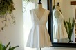 sleeveless vneck summer dress on mannequin, in front of a mirror