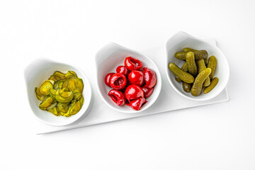 Wall Mural - Pickle appetizer mix on a white plate. Banquet festive dishes. Gourmet restaurant menu. White background.