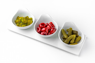 Wall Mural - Pickle appetizer mix on a white plate. Banquet festive dishes. Gourmet restaurant menu. White background.
