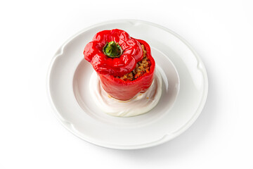 Wall Mural - Sweet pepper stuffed with bulgur, or rice and meat and vegetables, baked in the oven on a white plate. Banquet festive dishes. Gourmet restaurant menu. White background.