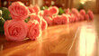 A row of pink roses are on a wooden floor. The roses are arranged in a way that they are all facing the same direction. Concept of elegance and beauty, as the roses are the focal point of the scene