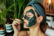 woman applying spirulina face mask in a spa setting