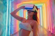 Happy woman in VR glasses on neon background, girl enjoying virtual video game or learning
