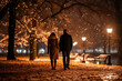 A man and a woman are walking side by side in a park at night, under dimly lit pathways and trees
