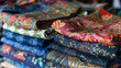 Close-up photo of an exquisite pile of beautifully patterned textiles showcasing various colors and designs