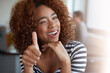 © peopleimages.com - Face, thumbs up and black woman with smile in office, workspace and working in creative career. Portrait, internship and journalist for magazine, newspaper and online publication with ok sign