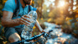 Cyclist hydrating with water bottle