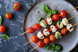Fototapeta Konie - Plate of Mozzarella and Cherry Tomato Skewers