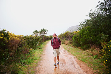 Canvas Print - Hiking, man and walk outdoor for travel, backpack and nature for fresh air and fitness on path for trip. Trekking, mountain trail and rough terrain for adventure, journey and exercise in environment