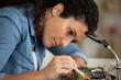 © auremar - young attractive female digital electronic device repair