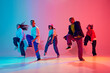 © Lustre Art Group  - Group of talented dancers practices choreographed number in neon light against gradient colorful studio background. Concept of hobby, sport, fashion and style, action, youth culture, music and dance.