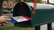 Close-up of person putting on letters with flag Iowa in mailbox