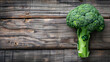 Fresh, vibrant broccoli adorning a wooden background, capturing attention with its bright color and natural appeal