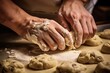 Close-up of a chef's hands pressing down cookie dough with a mold.