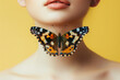 Butterfly in center of female neck isolated on yellow background. Concept of thyroid gland.