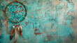 Beige brown dream catcher on turquoise textured background. Texture of concrete,Beautiful dream catcher on blue background, with feathers and beads

