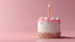 Delicious pink birthday cake with confetti sprinkles and festive balloons on a pink background.