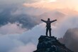 Hiker standing on a mountain peak, arms outstretched in victory.
