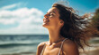 Beautiful happy woman with eyes closed and smile on amazing beach, wind playing with hair. Breathing deep, dreaming, meditation. Enjoy life, feel freedom. Summer vacation concept