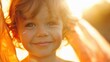 A joyful child with rosy cheeks and sparkling eyes smiling brightly against a warm sunlit backdrop.