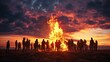 Valborg bonfire celebration in Sweden. Silhouettes of people standing around a bonfire.