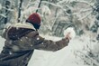 person with a snowball behind their back, sneaking up