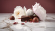 Chocolates and delicate pink and white flowers on an elegant marble background