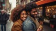 © inthasone - Happy African American couple hugging on the street in the city.