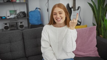 Poster - Cheerful redhead woman sparks a smart idea at home, pointing up with one finger in jubilant surprise, her face a beacon of success!