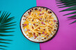 Children's pizza with french fries and sausage on a colored background blue and purple, top view