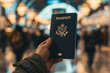 © Emanuel - An image of a person’s hand holding a passport