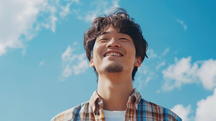 Smiling Man Wearing a Checked Shirt on Blue Sky. Asian, Chinese, Japanese, Korean, Asia, Japan, Korea, China, Male, Person, Smile, Happy, Portrait, Face, Fun, Cloud, Wind, Handsome
