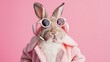 Amusing rabbit in pink coat wearing shades with earphones on pink background