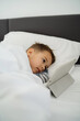 © blackday - Toddler Boy Engrossed in Tablet Technology in Bed