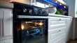 Energy efficient electric built-in oven at home kitchen. Modern black induction stove